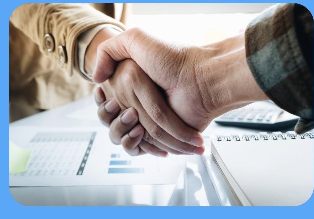 Two people shaking hands during a consultation